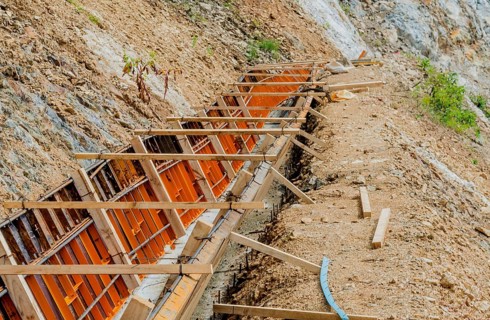 Construction form for man made drainage ditch on side of mountain