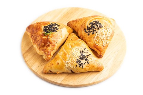 Homemade asian pastry samosa isolated on white background. side view, close up