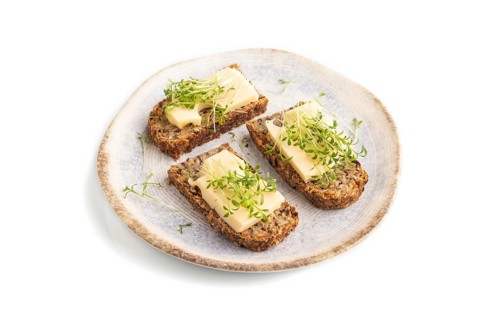 Grain bread sandwiches with cheese and watercress microgreen isolated on white background. side