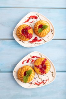 Semolina cheesecake with strawberry jam, lavender, on blue wooden background. top view, flat lay,