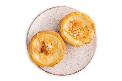 Traditional portuguese cakes pasteis de nata, custard small pies with almonds isolated on white