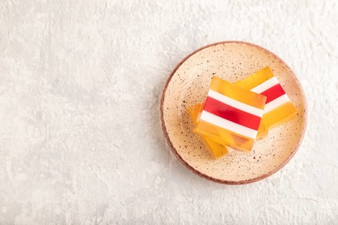 Almond milk and peach jelly on gray concrete background. top view, flat lay, copy space