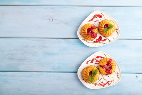 Semolina cheesecake with strawberry jam, lavender, on blue wooden background. top view, flat lay,