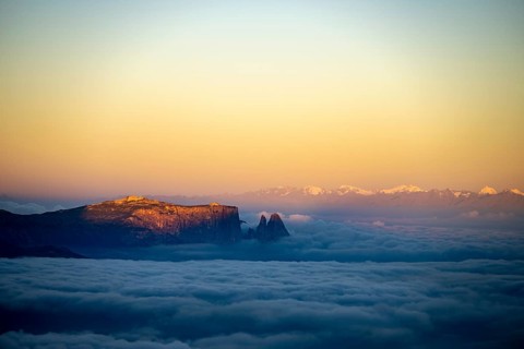 Sunrise over a sea of fog with the peaks of the Sella massif in the background, Corvara, Dolomites,