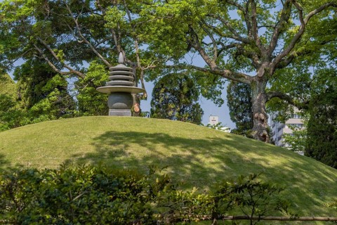 Round stone carved pagoda on hilltop in Hiroshima Peace Park in Hiroshima, Japan, Asia
