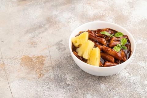 Tteokbokki or Topokki, fried rice cake stick, popular Korean street food with spicy jjajang sauce