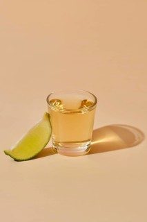 View from above on tequila shot with slice of lime
