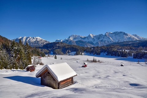 View of the frozen and snow-covered Geroldsee lake in Werdenfelser Land near Garmisch, with the