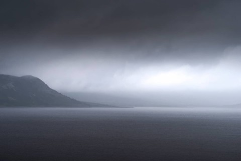 Uncomfortable atmosphere at lake Soenstevatn, landscape format, light mood, thunderstorm, rain,