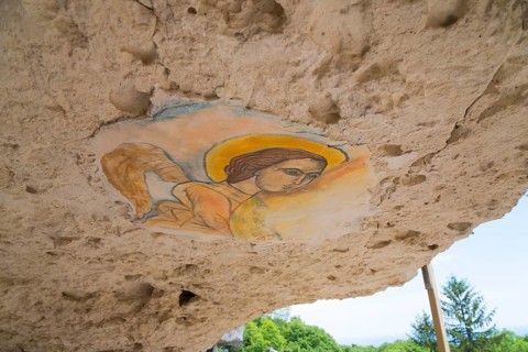 A ceiling fresco of an angel in a cave damaged by erosion, ceiling painting, Aladja Monastery,