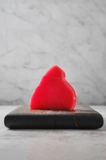 One piece of ahi tuna steak on wooden cutting board