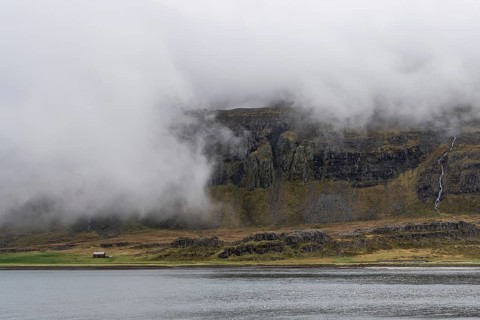 Cloudy mountains, waterfall, Reykjarfjoerour, Strandir, Arnes, Westfjords, Iceland, Europe