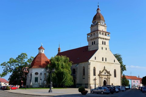 A Gothic church with a striking onion dome under a clear blue sky, St Michael's Roman Catholic