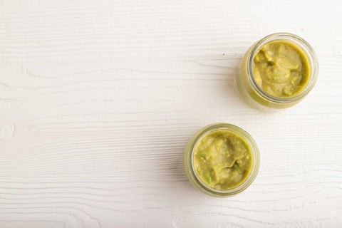 Baby puree with vegetable mix, broccoli, tomatoes, cucumber, avocado infant formula in glass jar on