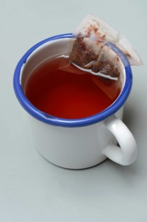 Red fruit tea in mug with tea bag, tea