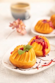 Semolina cheesecake with strawberry jam, lavender, cup of coffee on gray concrete background and