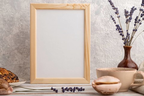White wooden frame mockup with lavender in ceramic vase, linen textile, cup of coffee and bun on