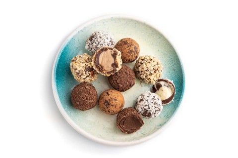 Chocolate truffle candies isolated on white background. top view, flat lay, close up