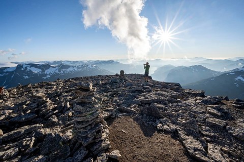 Mountaineers photographed, at the summit of Skala with cairns, view of mountain landscape and fjord