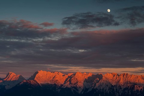 Distant view of steep mountains in the evening light, clouds, autumn, moon, view from Wank to