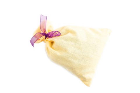 Yellow textile pouch isolated on white background. Top view, flat lay, close up