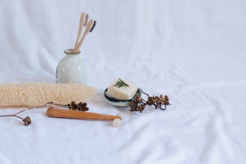 Eco-friendly personal care items with toothbrushes and soap dish on a white background, conveying a