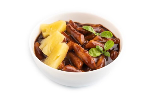 Tteokbokki or Topokki, fried rice cake stick, popular Korean street food with spicy jjajang sauce