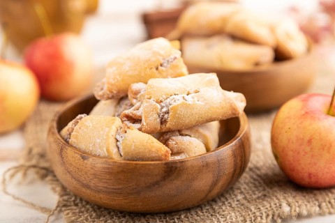 Homemade sweet cookie with apple jam and cup of coffee on white wooden background and linen textile