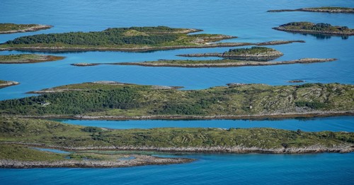 Rocky islands in the blue sea, sea with archipelago islands, Ulvagsundet, Vesteralen, Norway,