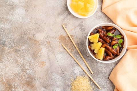 Tteokbokki or Topokki, fried rice cake stick, popular Korean street food with spicy jjajang sauce