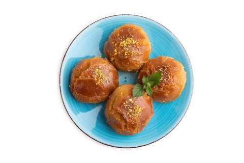 Homemade traditional turkish dessert sekerpare with almonds and honey isolated on white background.