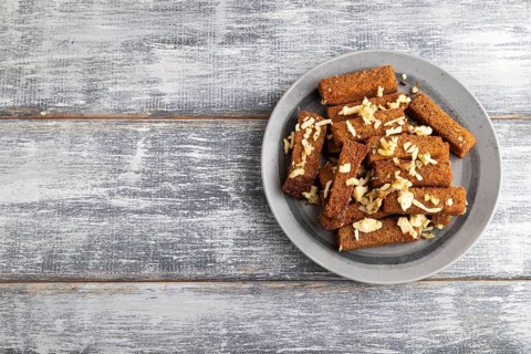 Cheese and toast on a gray plate on a gray wooden background. Top view, flat lay, close up, copy