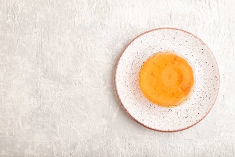 Papaya and orange jelly on gray concrete background. top view, flat lay, copy space