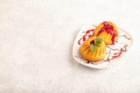 Semolina cheesecake with strawberry jam, lavender on gray concrete background. side view, copy