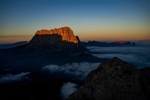 Sunrise over a sea of fog with the peaks of the Sella massif in the background, Corvara, Dolomites,