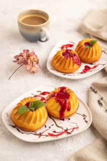 Semolina cheesecake with strawberry jam, lavender, cup of coffee on gray concrete background and