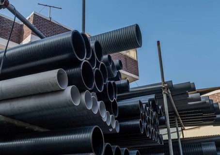 Large diameter pvc pipes stored on metal scaffolding outside