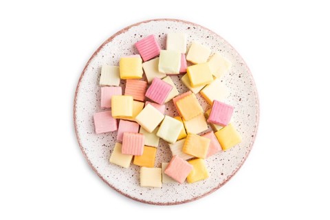 Various fruit jelly chewing candies on plate isolated on white background. apple, banana,