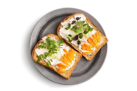 White bread sandwiches with cream cheese, calendula petals and microgreen radish and tagetes