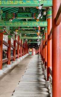 Colorful covered walkway with stairs and wheelchair ramp at Buddhist temple in South Korea