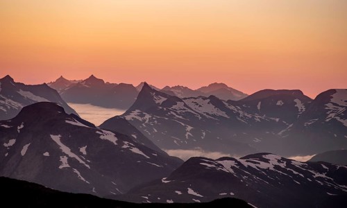 Mountain panorama, mountain peaks in soft light at sunset, view from the summit of Skala, Loen,