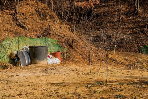 Daejeon, South Korea, January 24, 2020: Two large brown plastic tubs next to bags of fertilizer in