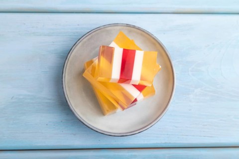Almond milk and peach jelly on blue wooden background. top view, flat lay, copy space