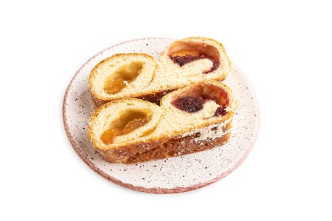 Homemade sweet bun with apricot jam isolated on white background. side view, close up