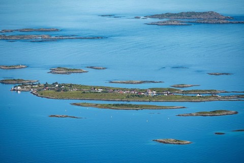 Rocky islands with colourful houses, sea with archipelago islands, Ulvagsundet, Vesteralen, Norway,