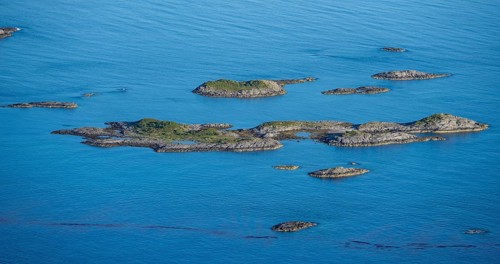 Rocky islands in the blue sea, sea with archipelago islands, Ulvagsundet, Vesteralen, Norway,