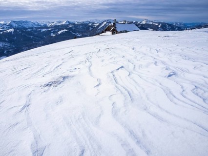 Winter atmosphere, snow-covered landscape, snow-covered alpine peaks, alpine hut on the