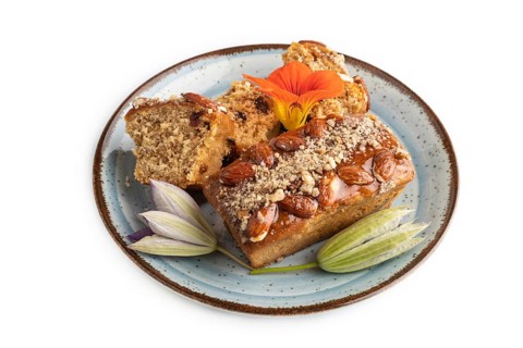 Caramel and almond cake isolated on white background. side view, close up