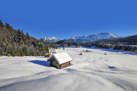 View of the frozen and snow-covered Geroldsee lake in Werdenfelser Land near Garmisch, with the