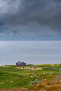 Shot of a hut on Lake Soenstevatn in the rain, portrait format, inland waters, log cabin, holiday